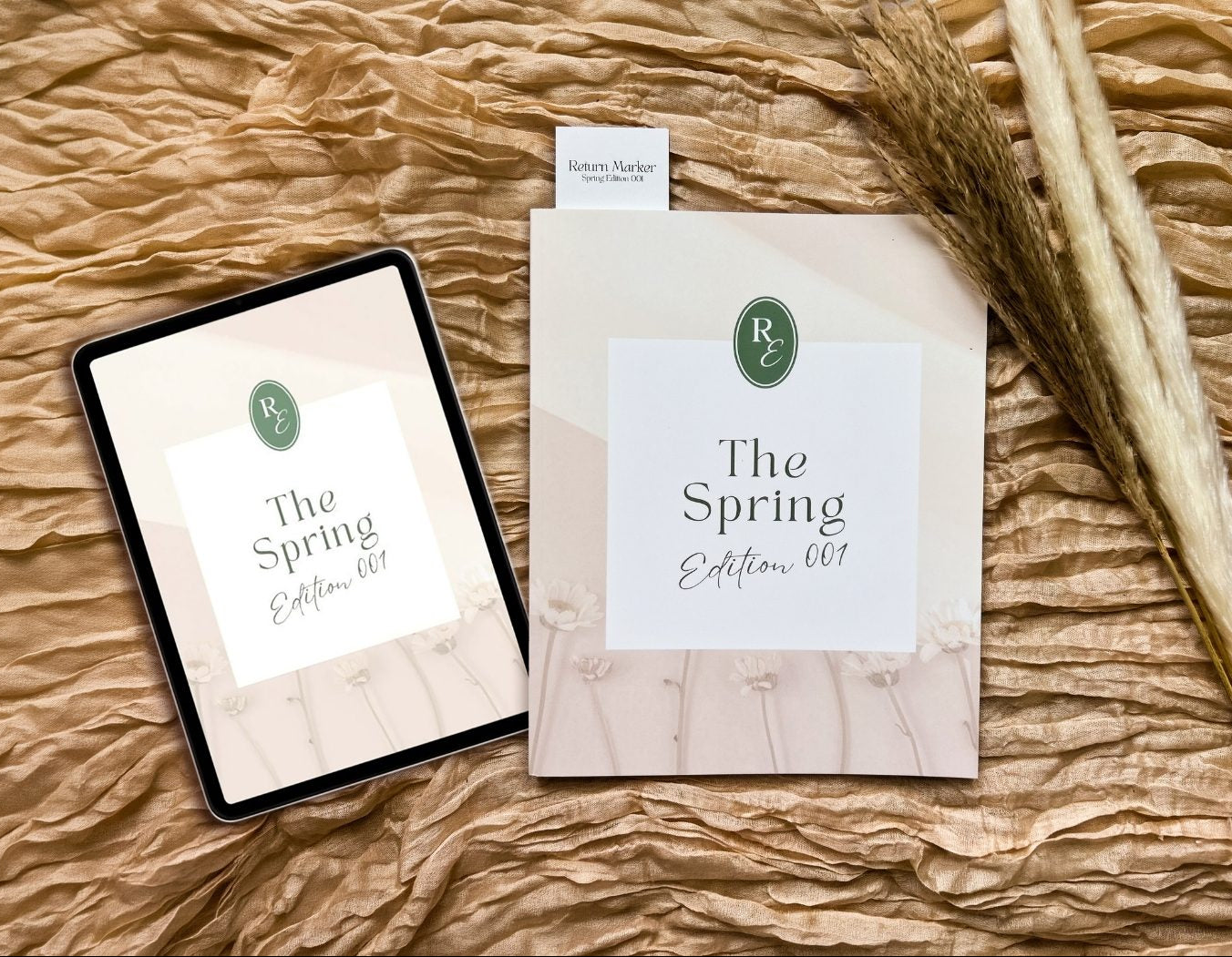 Tablet and paper with 'The Spring Edition 001' on a textured surface